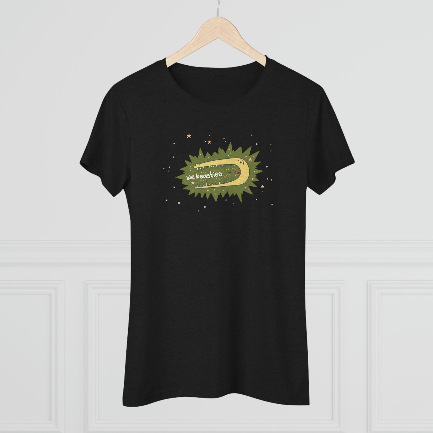A black t-shirt with the We Beasties logo (a yellow alligator on a green star burst surround by pink stars and the words "We Beasties" in the alligator's mouth.) The shirt hangs on a wood clothes hanger.