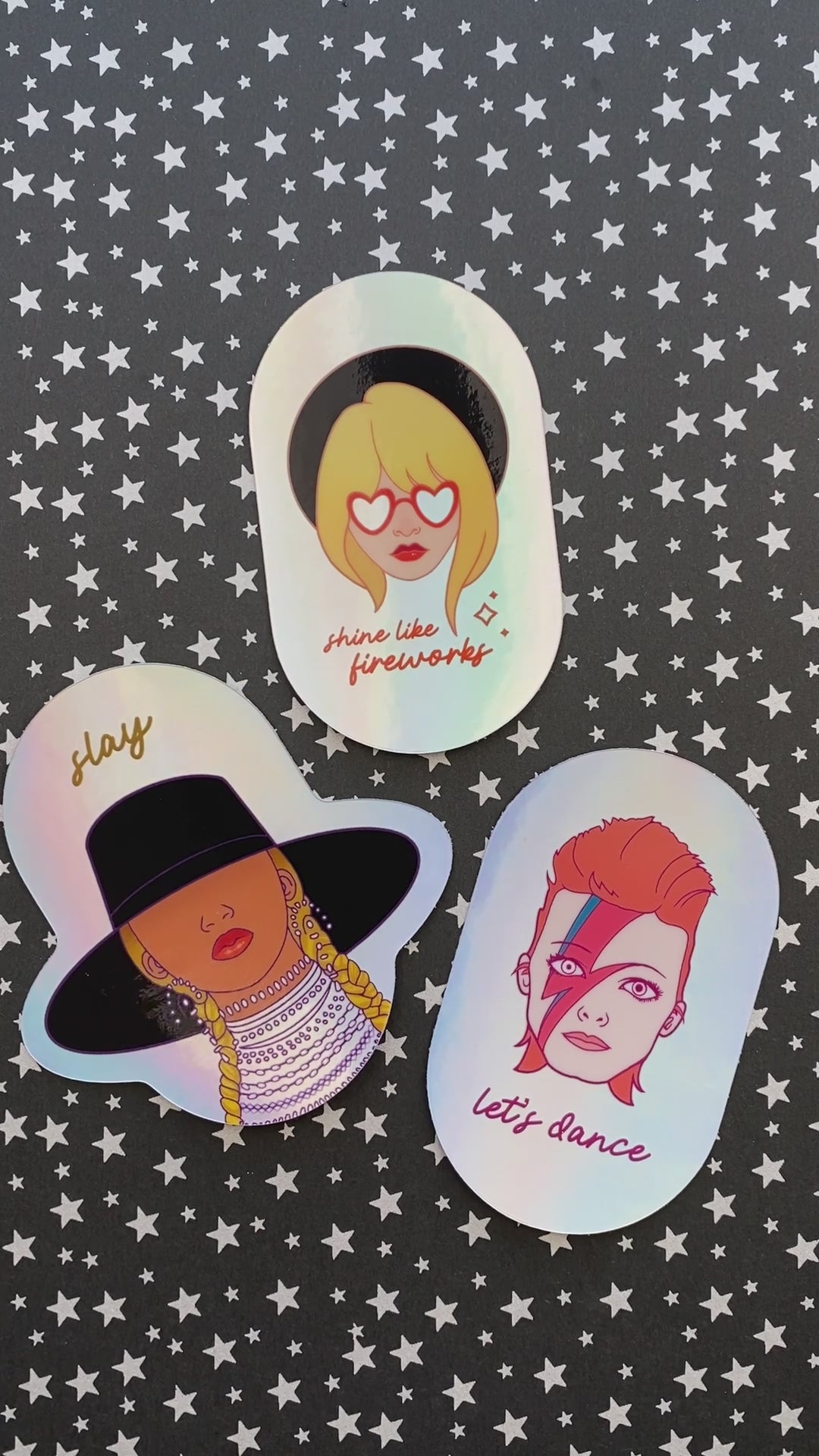 A video of holographic stickers of Taylor Swift, David Bowie, and Beyoncé. The stickers move to show off the holographic effect of the vinyl.