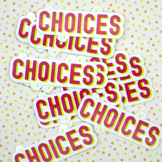 A picture of a pile of stickers that say "choices" in pink and yellow block font and are surrounded by stars. Stickres sit on a pink, yellow, and orange spotted background.