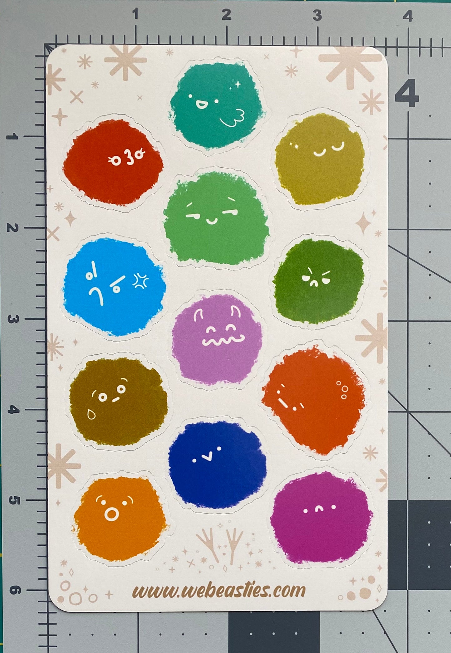 A photo the Fluffies sticker sheet against a ruled background to show its size.