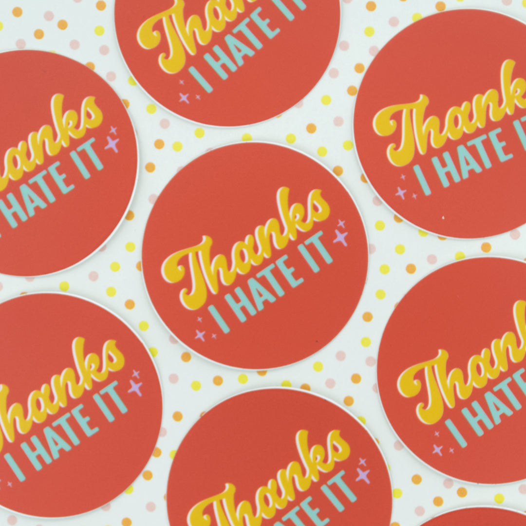 7 orange stickers with the words "Thanks I hate it" arranged in a circle.