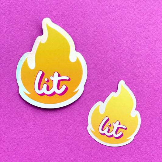 Two holographic stickers, one larger, one smaller. The sticker is an illustration of the "fire" emoji and inside is the word "lit" in script. The stickers sit on a bright purple paper background.